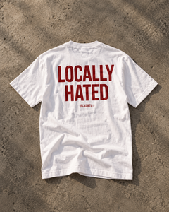 Locally Hated white T-shirt with red back print, editorial flat lay